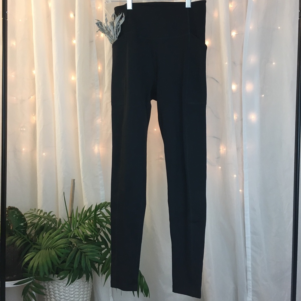 Black high-rise pocket leggings. 28.5" inseam.